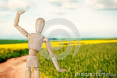 Composite image of wooden 3d figurine standing with hand raised Stock Photo