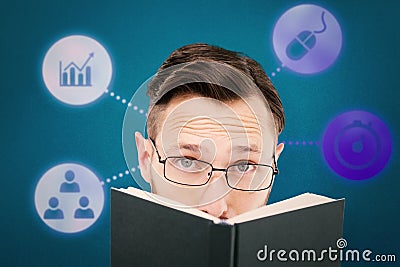 Composite image of young geek looking over black book Stock Photo