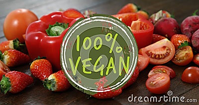 Composite of 100 percent vegan text over fruit and vegetables Stock Photo