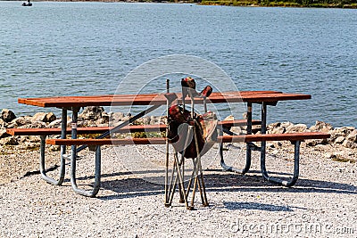 A composite picnic bench and table with an old washup garden chair Stock Photo