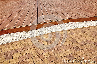 Composite Wood Decking, White Marble Gravel And Stone Brick Paving Stock Photo