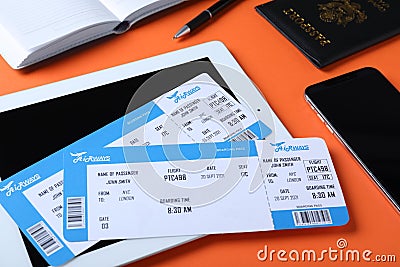 Composition with avia tickets and tablet on orange background. Travel agency concept Stock Photo