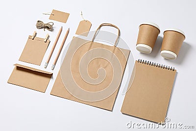 Composition with blank stationery, paper cups and bag on white background Stock Photo