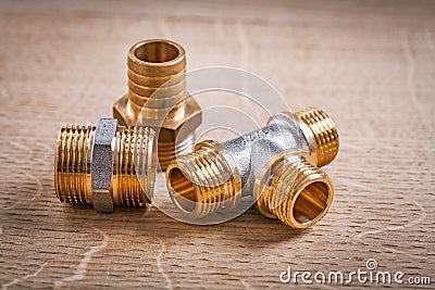 Composition Of Brass Pipe Connectors On Wooden Stock Photo