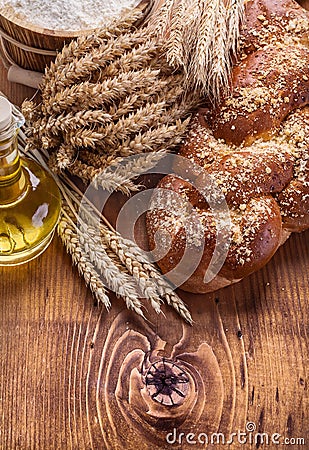 Composition bread bottle oil wheat ears flour in Stock Photo