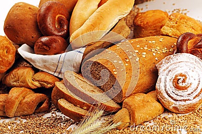Composition with bread and rolls in wicker basket, combination of sweet breads and pastries for bakery or market with wheat Stock Photo