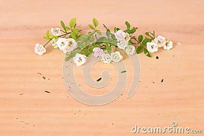 Composition of a bunch of small roses on a wooden table Stock Photo