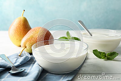 Composition with cream yogurts and fruits on white table Stock Photo