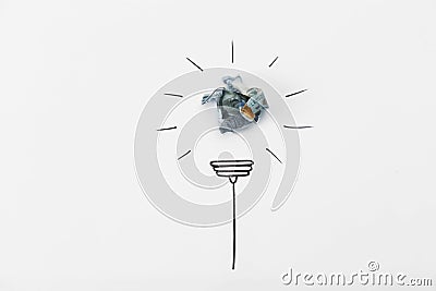 Composition with crumpled banknote and drawing of lamp bulb on white background, top view. Stock Photo