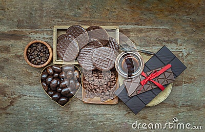 Composition of different Dark chocolate bars and pieces, Melted chocolate and Coffee beans on old wooden background Stock Photo