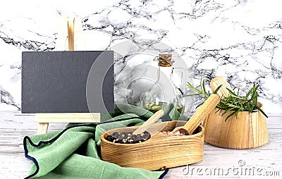 Composition with different spices on wooden double cellar and mortar with rosemary and green napkin, board for copy space, on Stock Photo