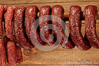 Many natural sausage hanged on wooden stick Stock Photo
