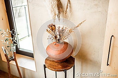 Composition of dried flowers in a clay vase Stock Photo