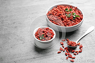 Composition with dried goji berries on grey table,. Healthy superfood Stock Photo