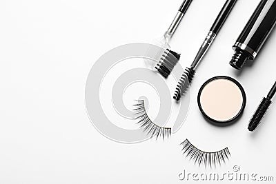 Composition with false eyelashes and other makeup products on white background Stock Photo