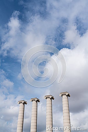 Composition of four ionic column with cloudy sky in the background in vertical view / copy space / pillar / architecture Stock Photo