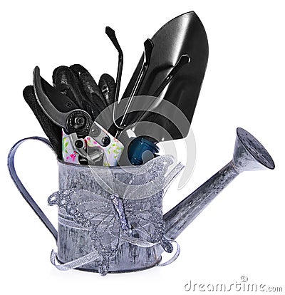 Composition of garden tools: silver watering can, colored shears Stock Photo