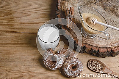 Composition gingerbreads, milk and honey and spices - cinnamon, coriander, stuffed gingerbread on a wooden background, top view, c Stock Photo