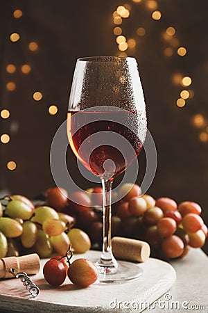 Composition with glass of wine and grape on brown background Stock Photo