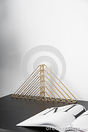 Composition of gold bookshelf and black and white standing on black wooden top with white background / interior design / compositi Stock Photo