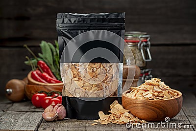 Composition with granulated dried garlic and flakes on wooden background Stock Photo