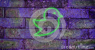 Composition of green neon bird icon on brick wall Stock Photo