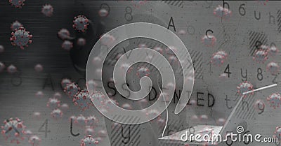 Composition of hooded hacker using laptop with covid cells and access denied message on screen Stock Photo