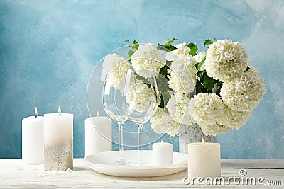 Composition hydrangea flowers against blue background. Romantic evening Stock Photo