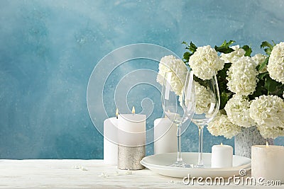 Composition hydrangea flowers against blue background. Romantic evening Stock Photo