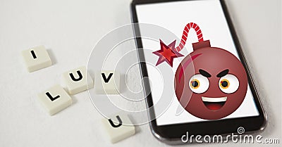 Composition of i luv you text on squares with bomb emoji over smartphone Stock Photo