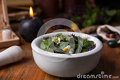 Composition with mortar, healing herbs and gemstones on wooden table Stock Photo