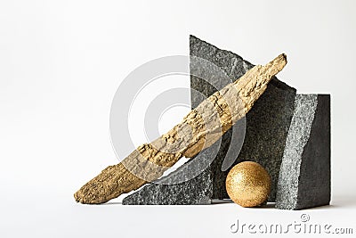 Composition with nature elements - stones, golden sphere and wooden log on white background Stock Photo