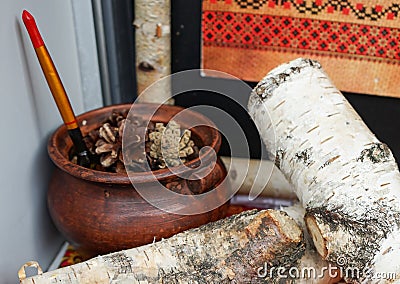 Composition with an old ceramic pot and birch logs Stock Photo