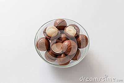 Macadamia nut shells macadamia in a glass jar on a gray concrete background Stock Photo