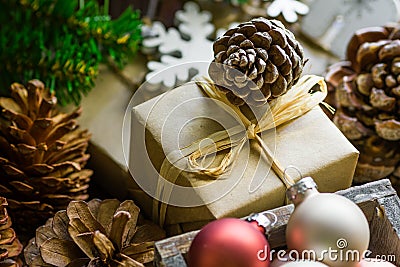 Composition from pile of Christmas and New Year gift boxes in craft paper, colorful balls, pine cones, fresh fir tree branches, wo Stock Photo