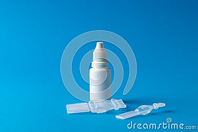 Composition of saline solution caplets and dropper bottle on blue background with copy space Stock Photo