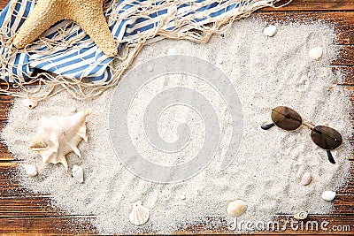 Composition with sand, sunglasses and starfish on wooden background Stock Photo