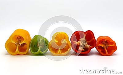 Composition of several halves of ripe sweet pepper of different colors on a light background. Stock Photo