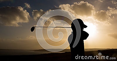 Composition of silhouette of golf player over landscape and clouds on blue sky with copy space Stock Photo