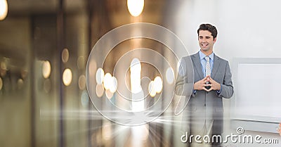 Composition of successful caucasian businessman smiling over blurred office corridor background Stock Photo