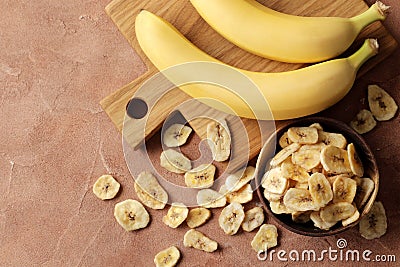 Composition with sweet dried banana slices, fresh bananas. Top view with space for text. Dried fruit as healthy snack Stock Photo