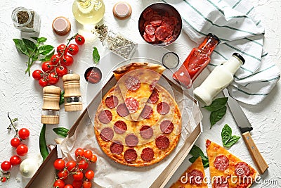 Composition with tasty Pepperoni pizza and ingredients on table Stock Photo