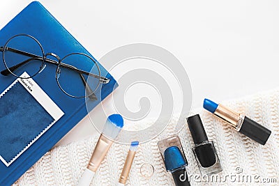 Composition top view. desktop notepad and cosmetics and turquoise fabric with a nap pleated. Color sample guide blue 2020 Stock Photo