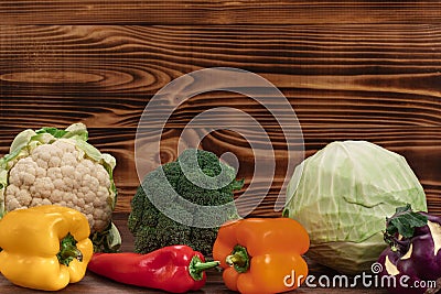 Composition with variety of raw organic vegetables on brown wooden background. Balanced diet, healthy food Stock Photo