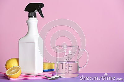 Composition with vinegar and cleaning supplies on table. Stock Photo