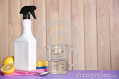 Composition with vinegar and cleaning supplies on table. Stock Photo