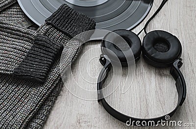 Composition, woolen sweatshirt black headphones and a large vinyl record Stock Photo