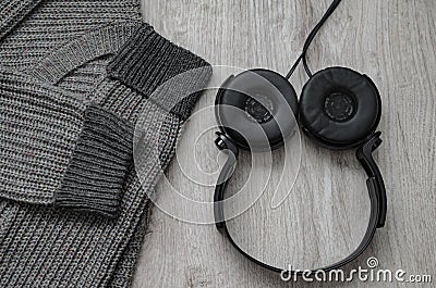 Composition, woolen sweatshirt and black headphones. Stock Photo