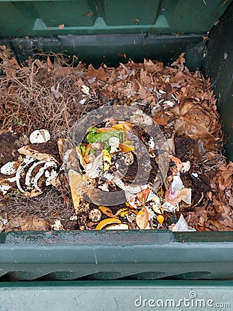 Compost bin with leaves and kitchen scraps Stock Photo