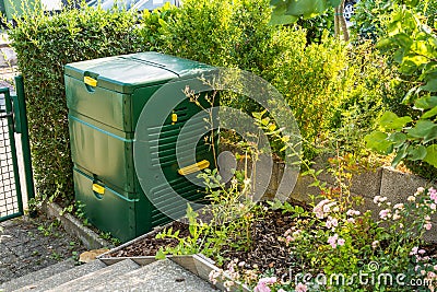 Compost maker bin for recycle kitchen, yard and garden scraps in small garden Stock Photo